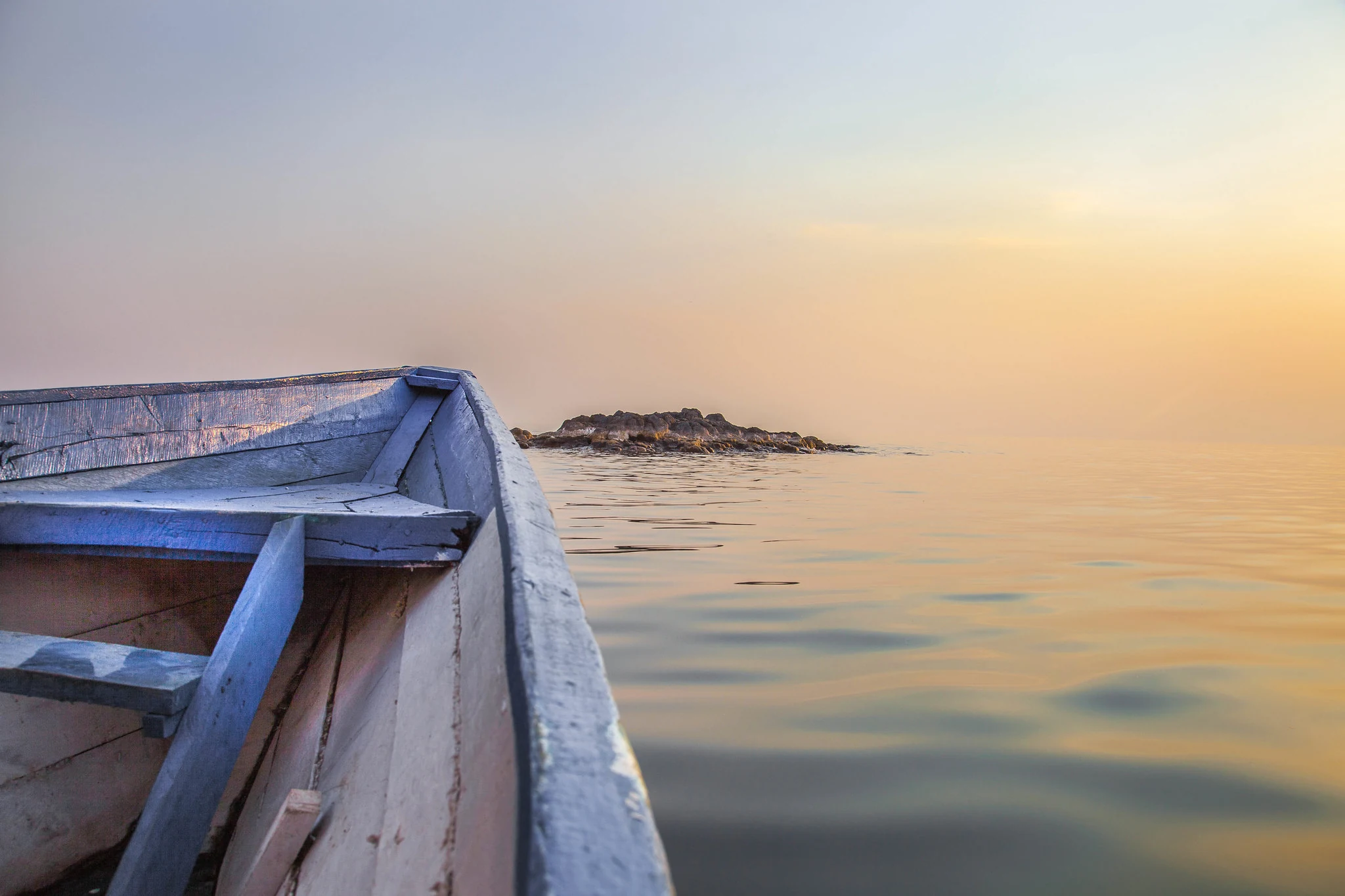 Boat silhouetted against a Lake Kivu sunset