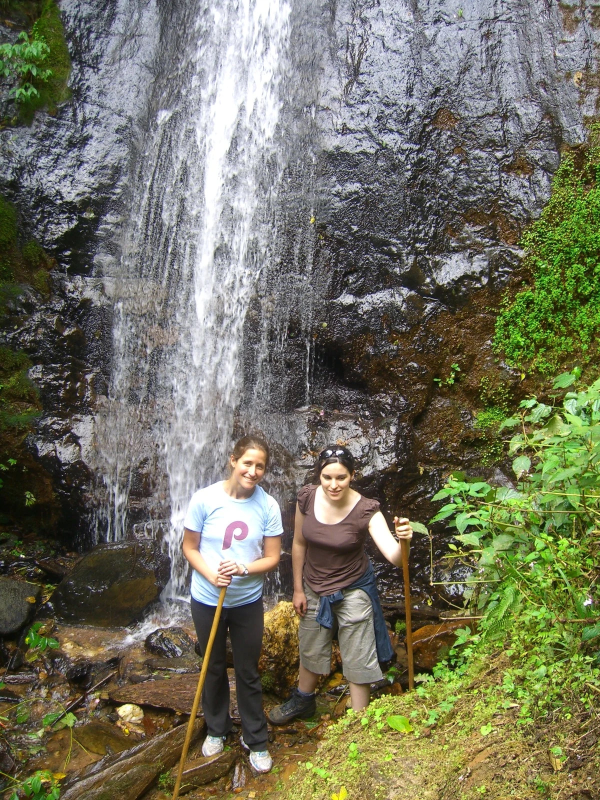 Guided hikers at a waterfall in Nyungwe National Park